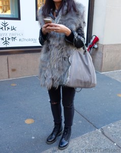 Fur vest with leather jacket underneath
